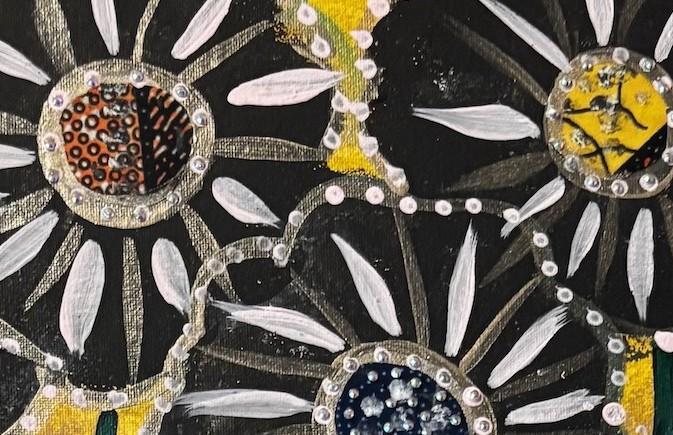 Close view of a flower: white petal strokes over black, edged with a row of small raised pearl dots.
